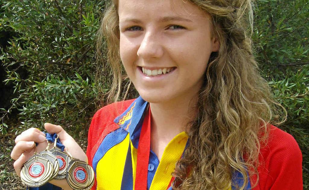 Warwick Swimming Club member Dimity Brackin with some of her recent medal wins. Warwick Swimming Club member Dimity Brackin with some of her recent medal wins.